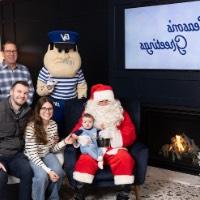 Baby boy on Santa's lap with parents and grandparents